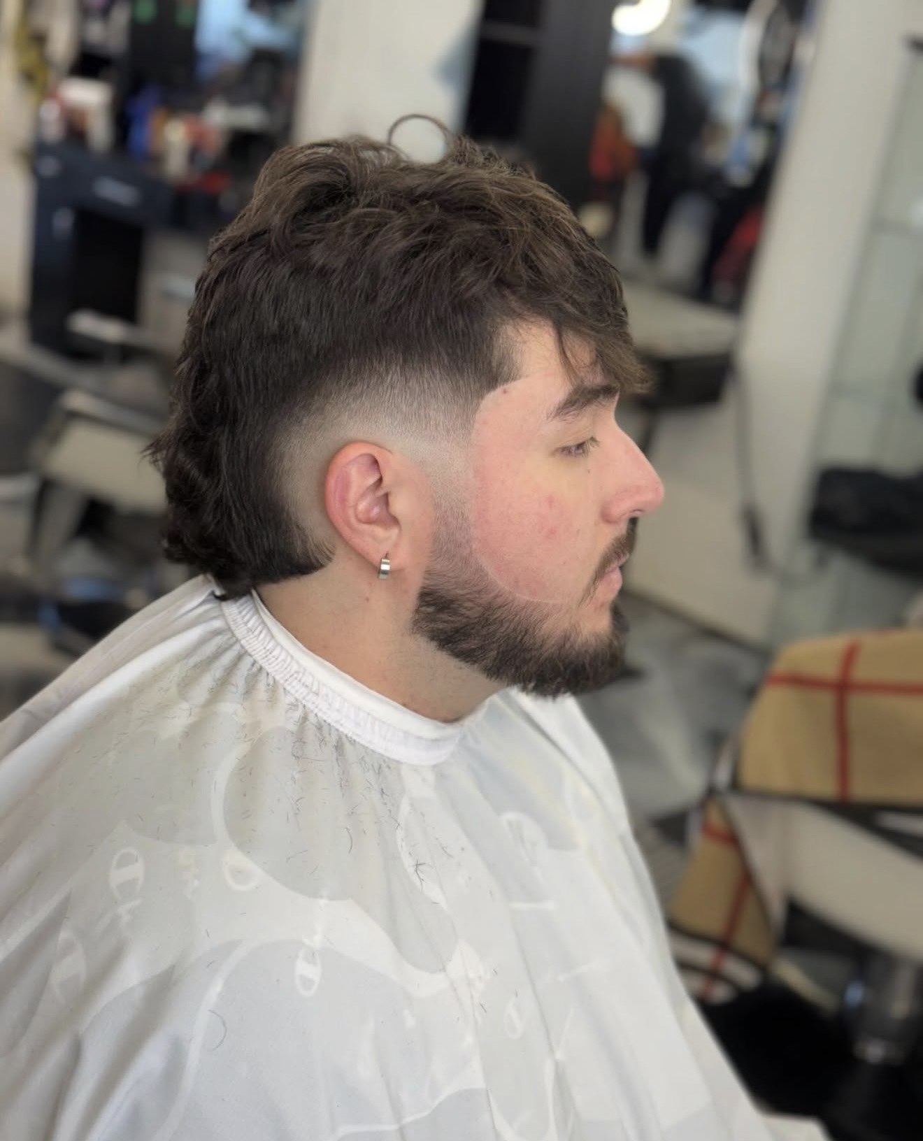 Modern mullet with mid drop fade and beard trim