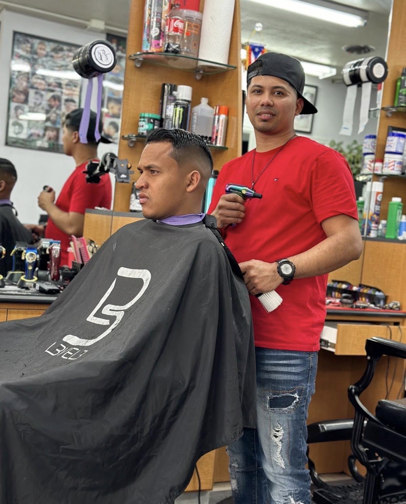 Barber finishing a classic high fade comb over