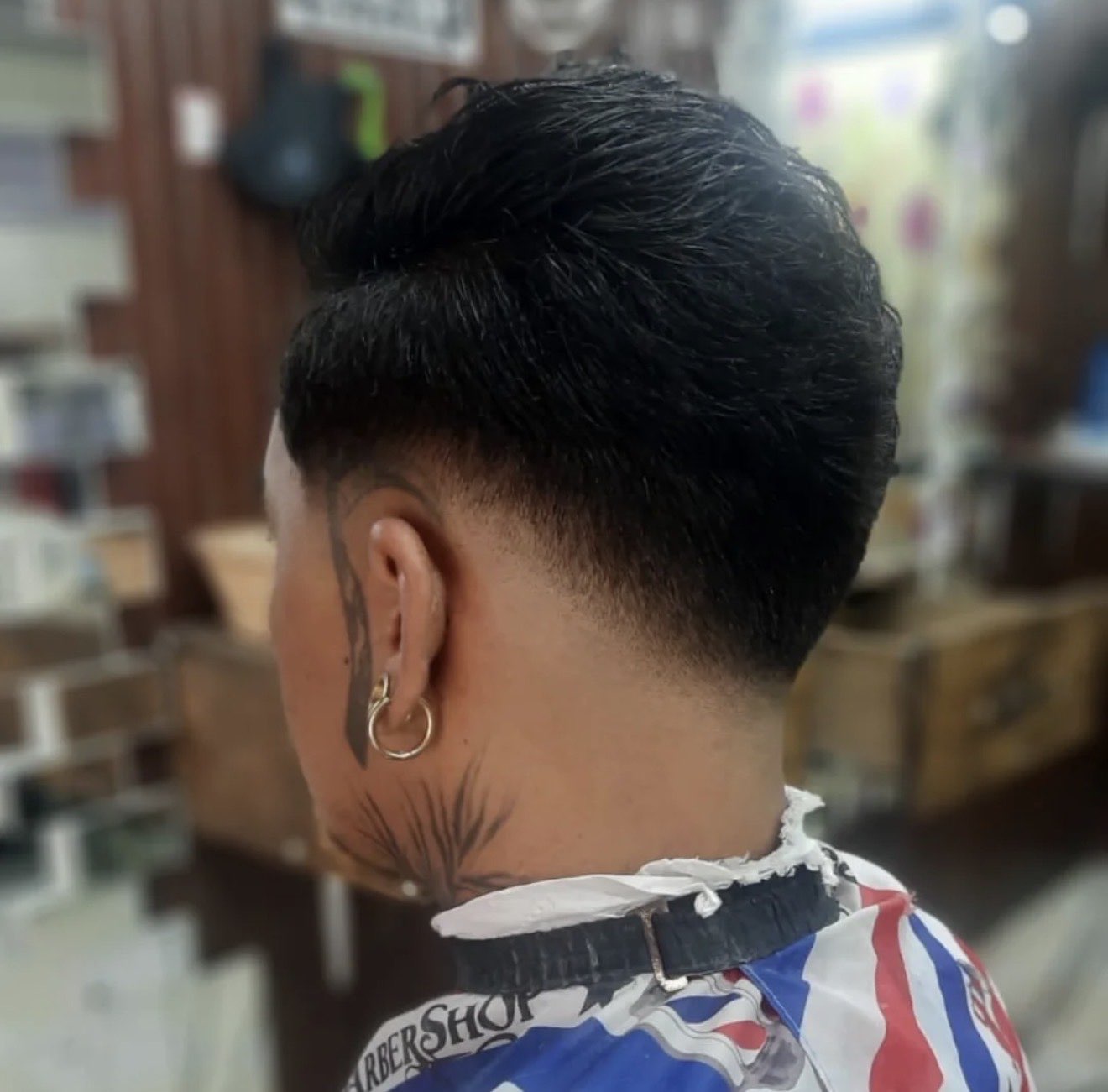 Low taper on straight black hair from the back